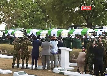 Tinubu presides over burial slain soldiers, gives them awards